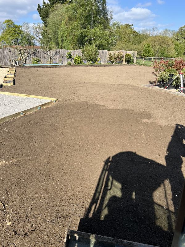 Large garden levelled and graded to an even finish, seen from the mini digger cab